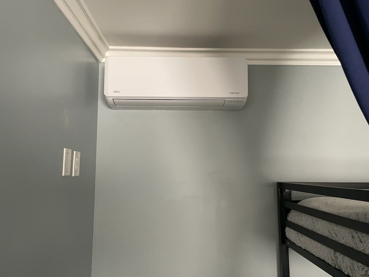 Wall-mounted mini-split system installed in a bedroom